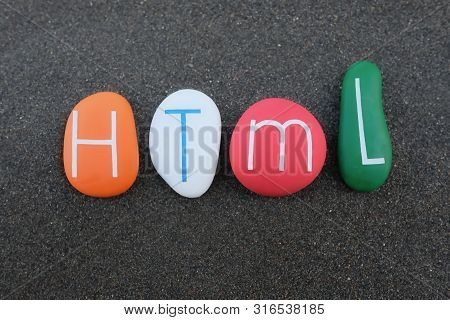 Html, Hypertext Markup Language Composed With Colored Stones Over Black Volcanic Sand