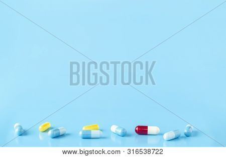 Various Medication Capsules. Blue Background With Text Space