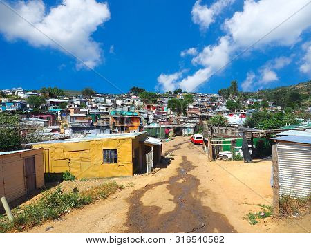 South Africans Walking On The Street Of Colorful Informal Settlements,huts Made Of Metal In The Town