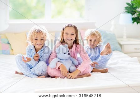 Kids Play In Bed. Children At Home.