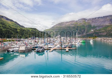 WHITTIER ALASKA/UNITED STATES - July 28: Boats are moored at the marina and are very protected in this harbor surrounded by mountains on 07/28/19 in Whittier AK.