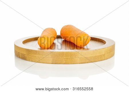 Group Of Two Whole Stale  Orange Stale Baby Carrot Baby On Bamboo Plate Isolated On White Background