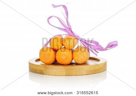 Group Of Five Whole Stale  Orange Stale Baby Carrot Baby On Bamboo Plate Isolated On White Backgroun