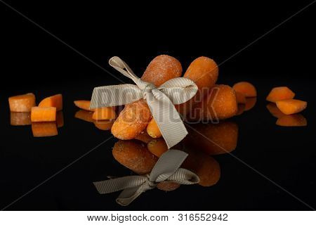 Group Of Three Whole Lot Of Pieces Of Stale  Orange Stale Baby Carrot Baby With Bow Isolated On Blac