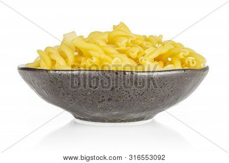 Lot Of Whole Raw Pasta Gemelli On Grey Ceramic Plate Isolated On White Background