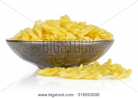 Lot Of Whole Twisted Raw Pasta Gemelli On Grey Ceramic Plate Isolated On White Background