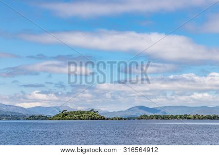 Lough Corrib With Forest And Conerama Mountains In Background