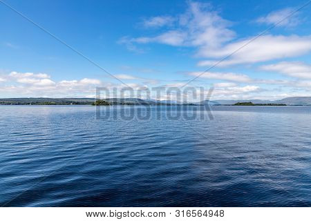 Lough Corrib With Forest And Conerama Mountains In Background