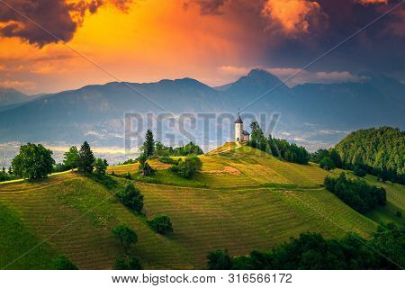 Mountain Landscape With Church On The Hill. Beautiful Colorful Sunset Landscape And Spectacular Sain