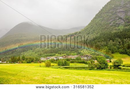 Colorful Rainbow Over The Fields, Lake And Houses Of Skei Village, Jølster In Sogn Og Fjordane Count