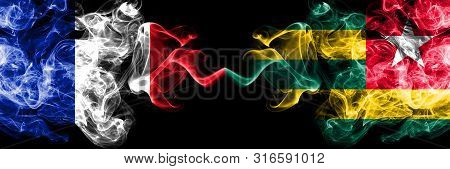 France Vs Togo, Togolese Smoky Mystic Flags Placed Side By Side. Thick Colored Silky Abstract Smokes