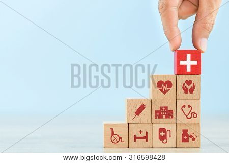 Health Insurance Concept,hand Arranging Wood Block Stacking With Icon Healthcare Medical.