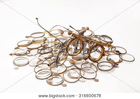 Old Optometric Devices And Set Of Lenses On An Isolated Studio Background