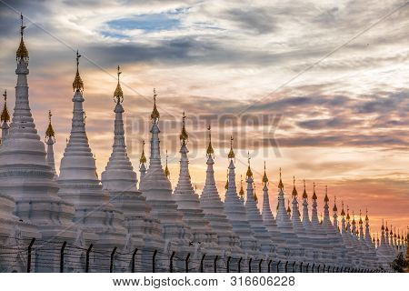 Pagoda Series In Line At Sunset In The Mandalay Region, Aungmyaythazan In Burma. Sanda Muni Pagoda, 