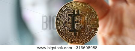 Minsk, Belarus, June, 2019: Hacker Wear Anonymus Mask Hold Bitcoin In Hand Illustrative Editorial