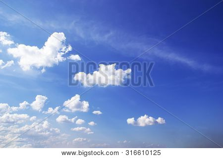 Blue Sky Background And White Clouds Soft Focus, And Copy Space