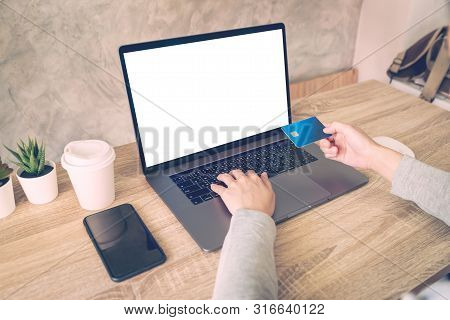 Asian Woman Using Laptop Computer Do Online Activity Pay Credit Card On Wood Table.
