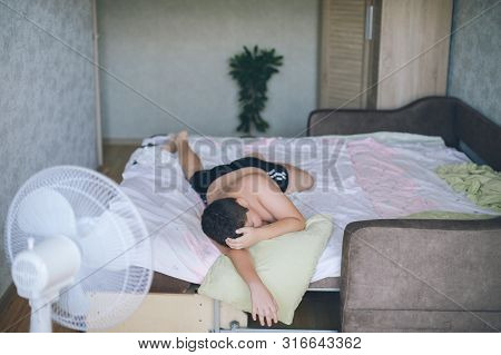 Sleeping Little Caucasian Relaxing Child Lying On Green Pillow During Deep Sleep In Morning On Large