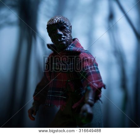AUG 9 2019: Horror movie werewolf lurking in the forest at night during a full moon - Mego action figure