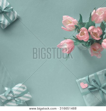 Blue Background With Pink Tulips, Stripy Wrapping Paper And Wrapped Gift Boxes. Flat Lay, Square Com