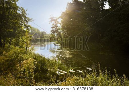 Am idilic pond overlooking the river with boat