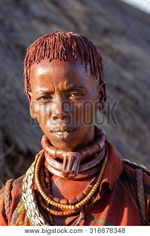 Turmi, Omo River Valley, Ethiopia - May 10, 2019: Portrait Of A Hamar Woman In Village. The Hamer Ar