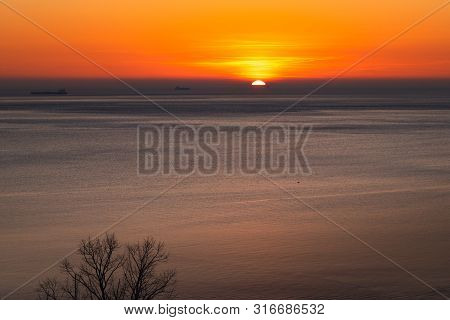 Sunset Over The Sea Horizon Nature Landscape. Red Clouds And Sea Landscape. Sea Nature In Sunset. Na