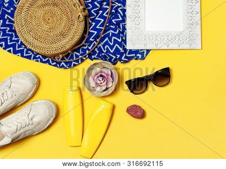 Female Summer Fashion Background. Clothes And Accessories On Yellow Background. Blue Dress, Round Ra