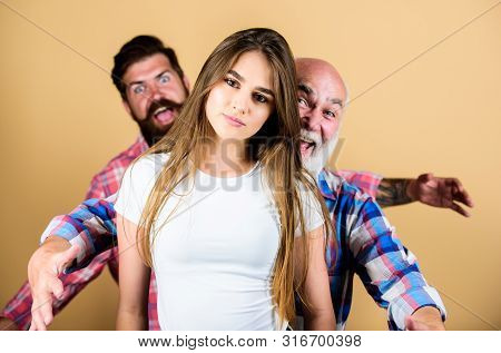 Psychology Anxiety. Two Bearded Men Scare And Chase Young Woman. Family Values. Generation And Gende