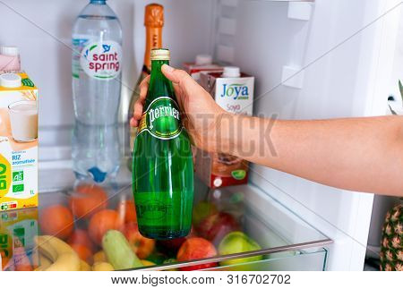 Tambov, Russian Federation - June 10, 2019 Person Hand Taking Out Perrier Water Bottle From The Frid