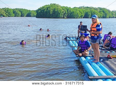Chantaburi, Laem Sing, Thailand - 26 July 2019 Tourists Floating On Pvc Pipe Raft In The Lake Of Lae