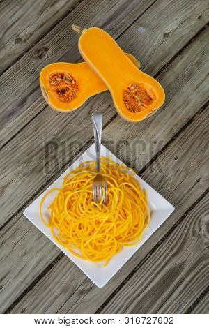 Top View Of Healthy Butternut Squash Noodles With Fork Stuck In Pasta