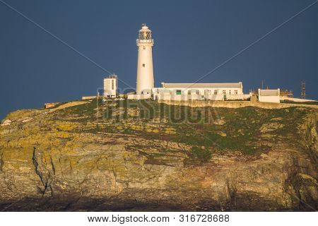 Lighthouse On Rocky Outcrop In Morning Light, Landscape