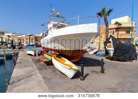 Traditional Fishing Boats Called Luzzu In The Bay Of The Village Marsaxlokk. Malta.
