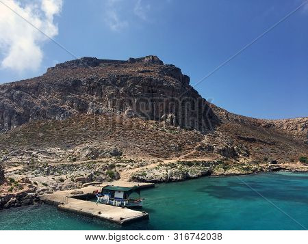 The Island Of Gramvousa In Crete, Greece. Tourist Boat Docked On The Bay Of Gramvousa Island On A Su