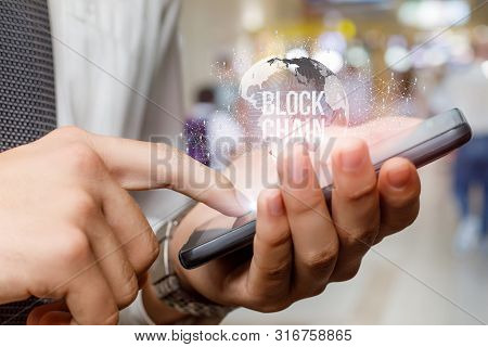 Businessman Running On A Mobile Phone With The Sequential Block Chain .