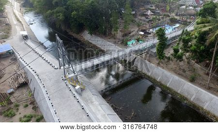 A Suspension Bridge Crosses The River. Supporting Inter-regional Transportation Facilities. Traffic 
