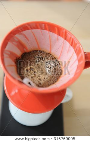 Freshly Coffee Blooming Into Red Hario V60 Funnel.