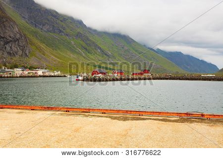 Fjord Coast Landscape. Typical Norwegian Fishing Village With Traditional Red Rorbu Huts, Ramberg, L
