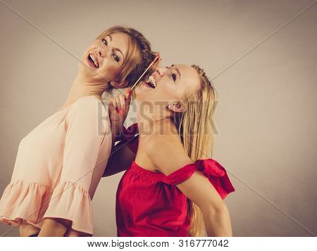 Happy Two Women Holding Paper Decoration Photo Booth Mask Glasses On Stick, Having Fun. Wedding, Bir