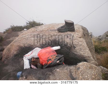 Tradition Of Pilgrims At The End Of The Santiago Walk Deposit Used Clothing In Finisterre. August 7,