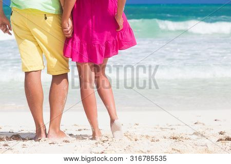 Legs Of Young Hugging Couple On Tropical Turquoise Beach. Cayo Largo, Cuba