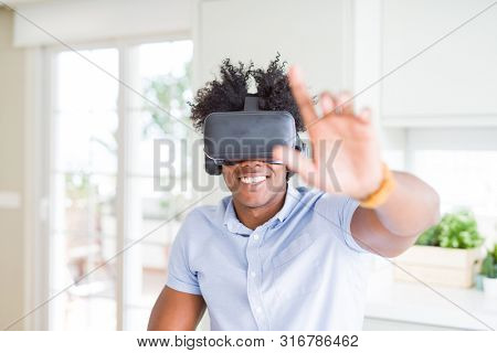 African amaerican man having fun playing with virtual reality glasses