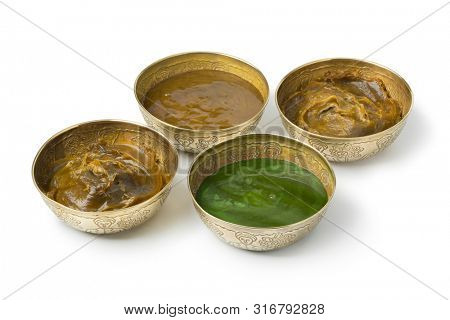 Diversity of Savon beldi in decorated metal cups isolated on white background