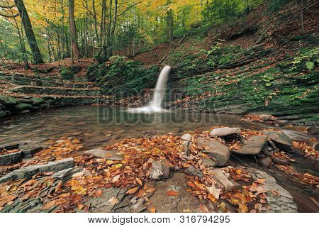 Autumn Mountain Waterfall Stream In The Rocks With Colorful Red Fallen Dry Leaves, Natural Seasonal 