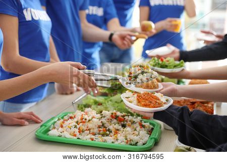 Volunteers Serving Food To Poor People, Closeup