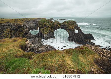 Amazing Seascape, Gatklettur Basalt Rock Arch At The Volcanic Cliff, Atlantic Coast Of Arnarstapi In
