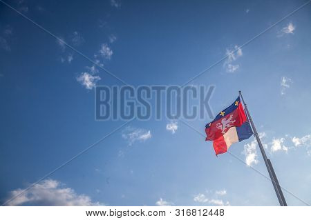 Ville De Lyon City Coat Of Arms On A Flag Waiving In Front Of The French Flag In Lyon, France. These