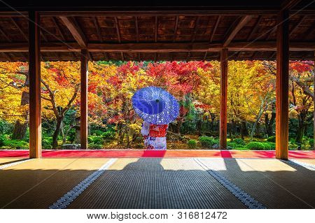 Asian Woman Wearing Japanese Traditional Kimono In Autumn At Enkoji Temple, Kyoto, Japan.