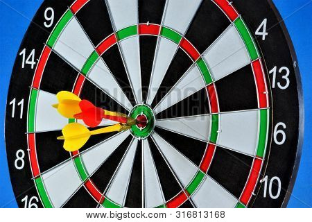 The Target For The Sport Of Darts And The Darts Hit The Target. Darts Game In Which Opponents Throw 